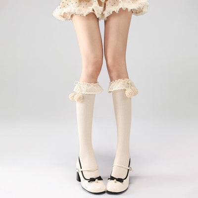 Apricot calf socks with lace details worn by a person on a light gray background