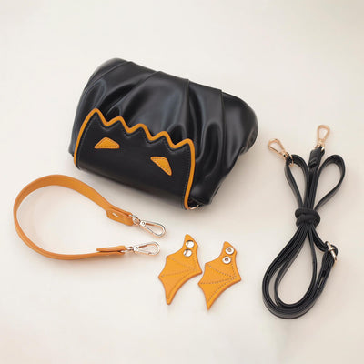 Bag_Composition_Including_A_bag_body_A_Detachable_Handle_Strap_And_A_Detachable_Black_Shoulder_Strap_And_A_Pair_Of_Wings