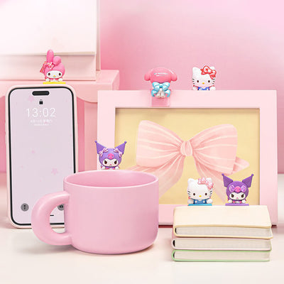 Bow-Sweet-Sanrio-Characters-Lying-Down-on-Mug-on-Phone-on-Book