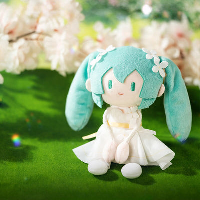 Haatsune Miku in white dress on a green background with cherry blossoms