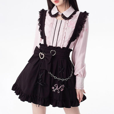 Girl wearing a black and pink outfit with a heart-shaped belt on a white background