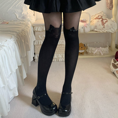 Girl wearing black knee-high socks with cat ears and black shoes in a room setting.