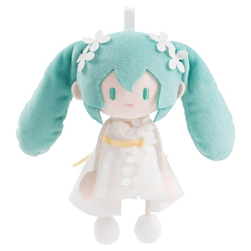Plush Miku wearing a green outfit and white dress on a white background