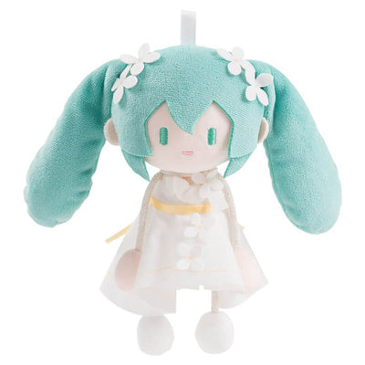 Plush Miku wearing a green outfit and white dress on a white background