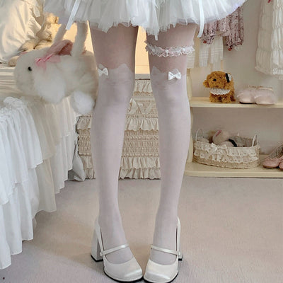 White Cat tights with bow details worn by a girl in a room with toys and furniture.