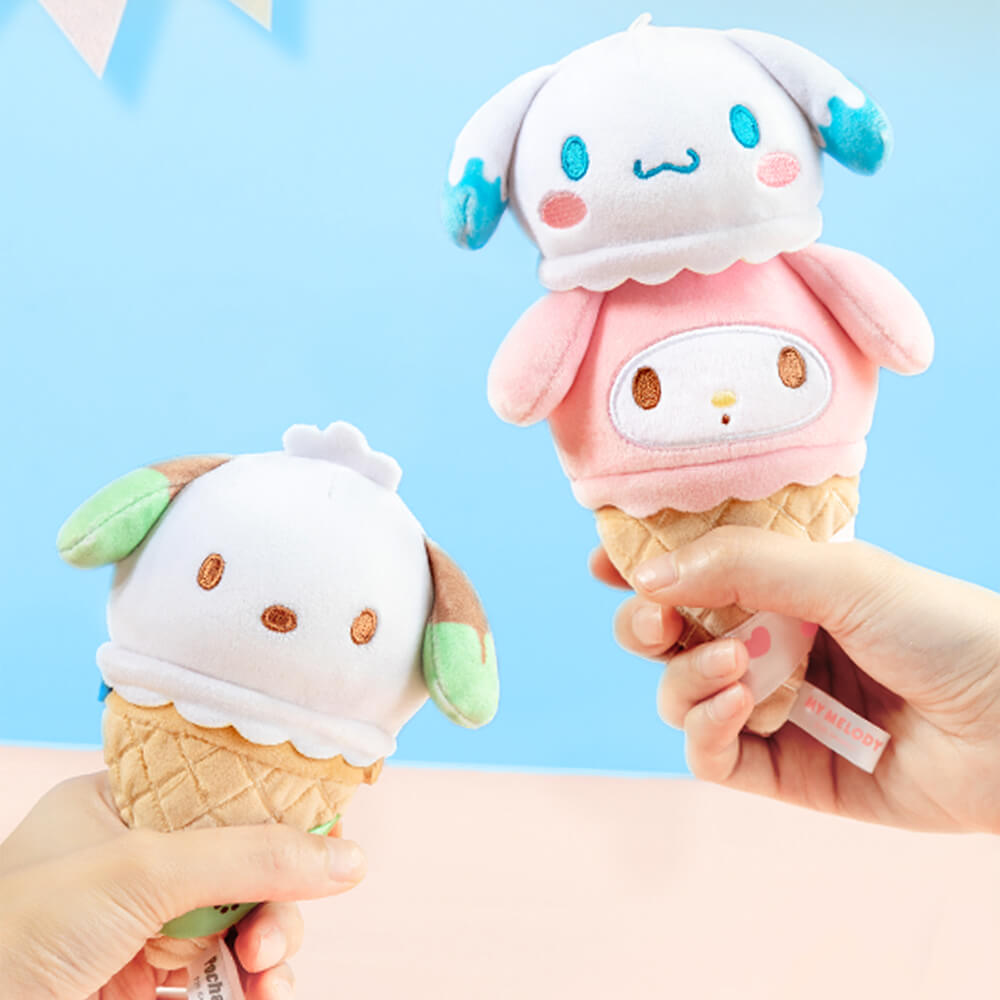 Two plush ice cream cones with cartoon faces against a blue background