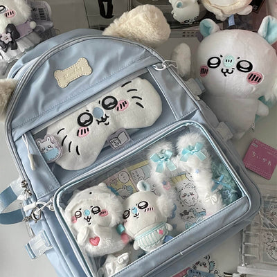 light-blue-school-backpack-filled-with-cute-dolls
