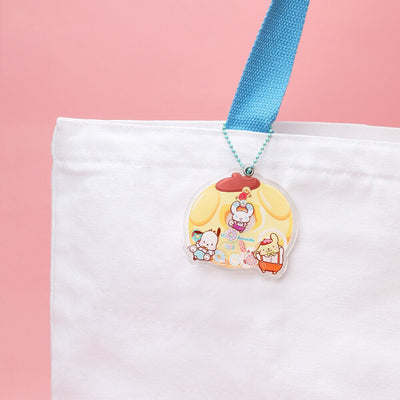 playful-pompompurin-donut-shaped-acrylic-charm-attached-to-a-white-canvas-bag