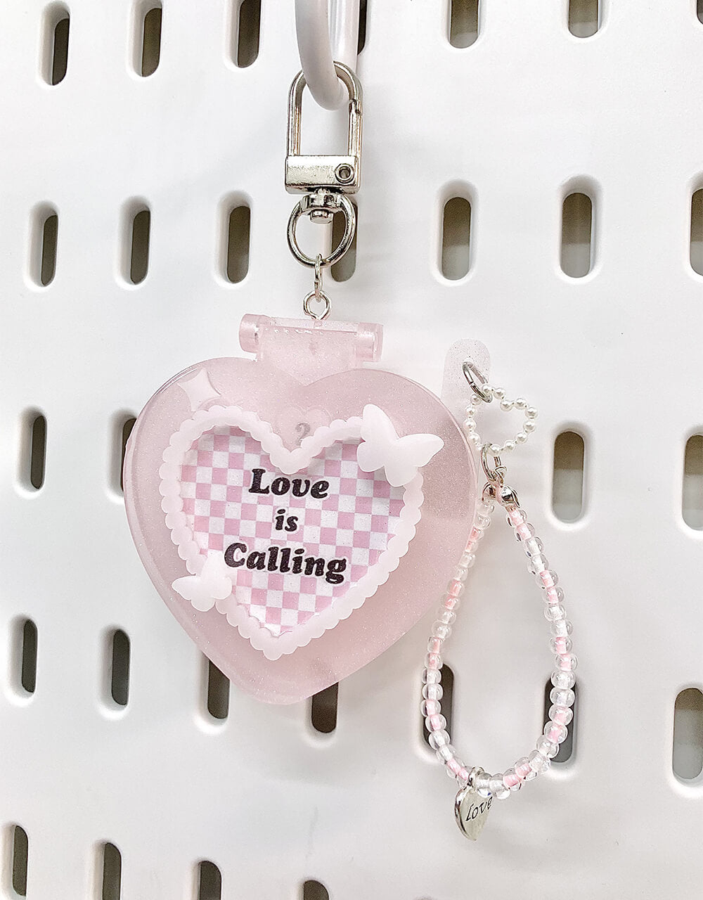 Custom-Photos-Pink-Heart-Shaped-Flip-Phone-Charm-Keychain-hanging-on-pegboard