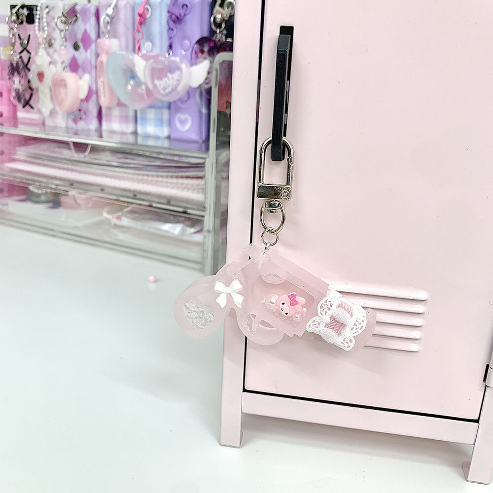Lovely-Pink-Gun-Epoxy-Resin-Shaker-Charm-Keychain-hang-on-pink-cabinet